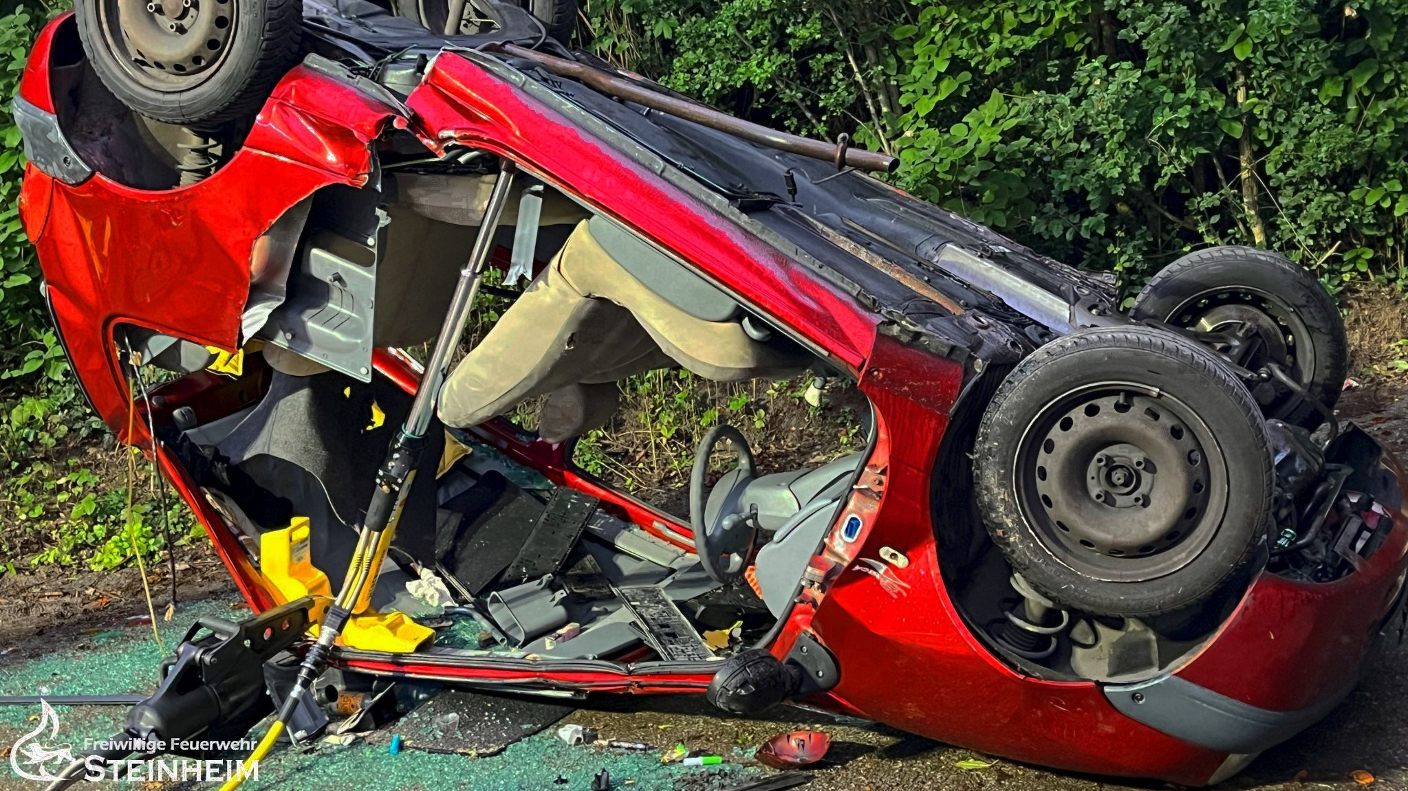 Ein von der Feuerwehr zerschnittenes Fahrzeug liegt auf dem Dach